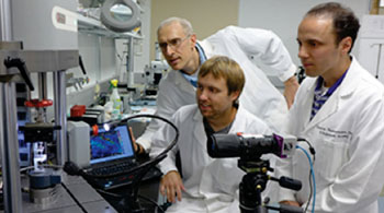 Image: From left, Guy Genin, PhD, John Boyle and Stavros Thomopoulos, PhD, watch as a sample is exposed to stress and force. They have developed algorithms that may lead to the ability to identify weak spots in tendons, muscles and bones (Photo courtesy of Washington University in St. Louis). Image: From left, Guy Genin, PhD, John Boyle and Stavros Thomopoulos, PhD, watch as a sample is exposed to stress and force. They have developed algorithms that may lead to the ability to identify weak spots in tendons, muscles and bones (Photo courtesy of Washington University in St. Louis).