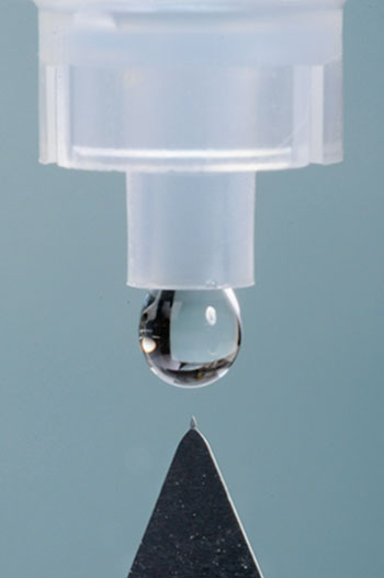 Image: Solid microneedles coated with Bevacizumab (syringe for scale) (Photo courtesy of the Georgia Institute of Technology).