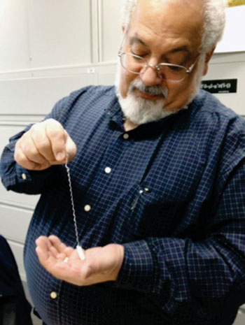 Image: Professor Steven Ackerman holding the EnteroTrack capsule device (Photo courtesy of UIC).