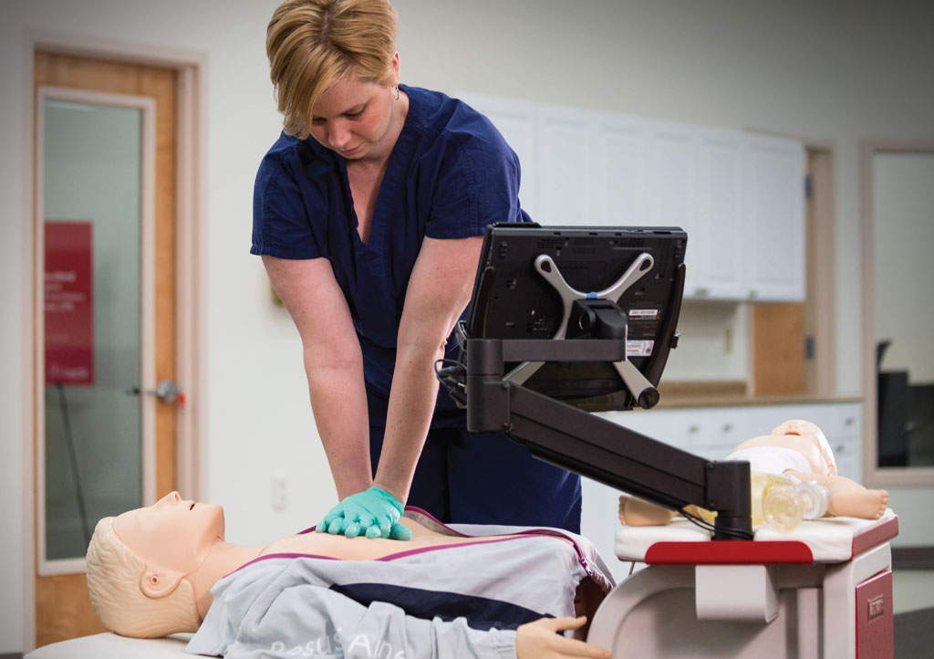 Image: A nurse practicing CPR to meet RQI requirements (Photo courtesy of the AHA).