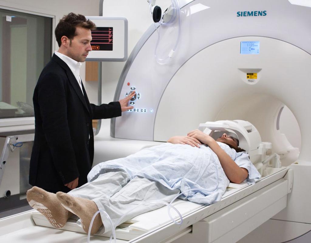 Image: Dr. Josh Buckholtz, PhD, and the Psychiatric Neuroimaging Division MRI scanner (Photo courtesy of MGH).