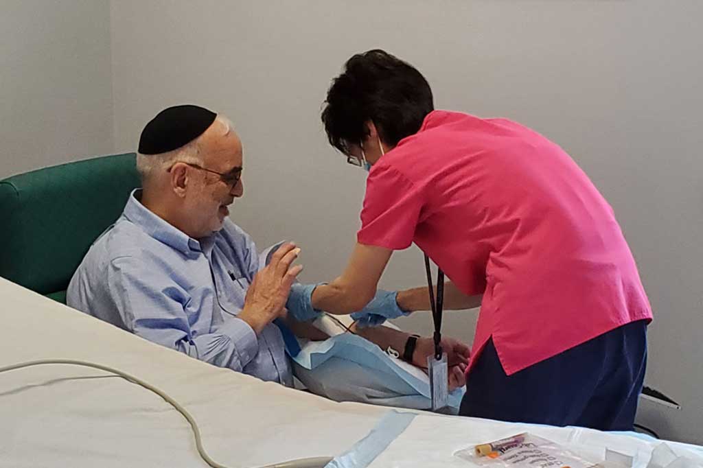 Image: A study volunteer who has recovered from COVID-19 donates blood at the Rockefeller University Hospital (Photo courtesy of The Rockefeller University)