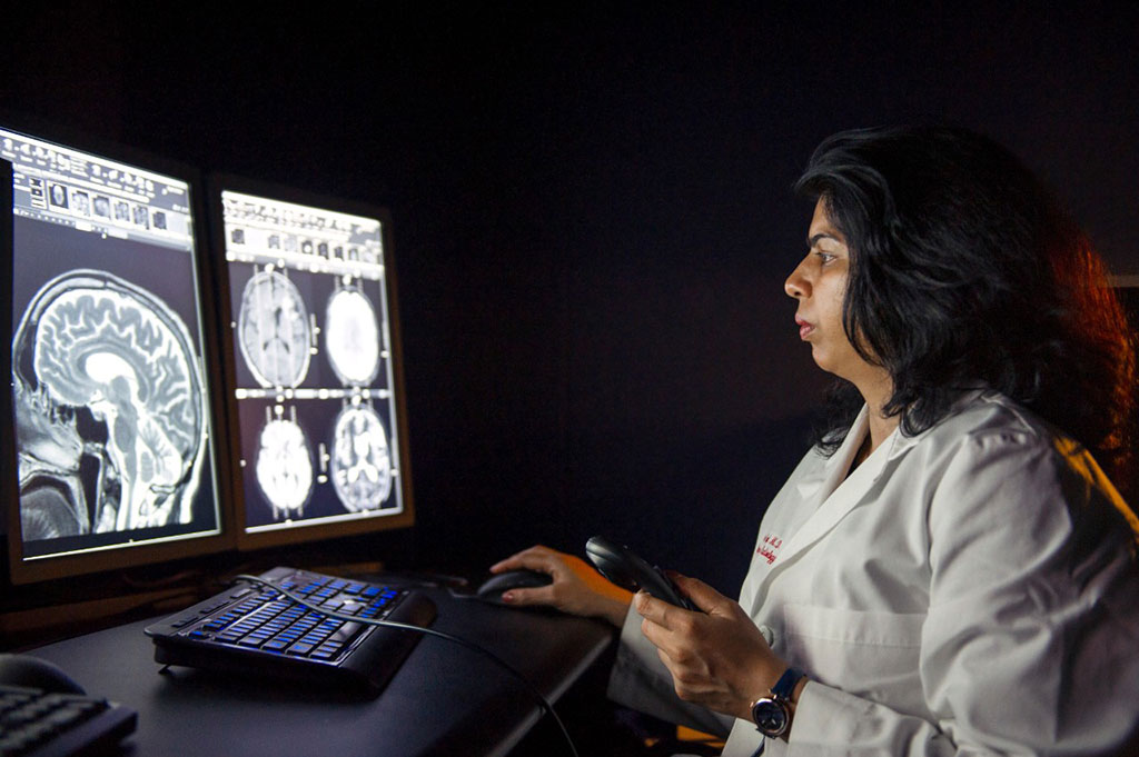Image: Achala Vagal, MD, author on the study, reviews an MRI scan (Photo courtesy of Colleen Kelley)