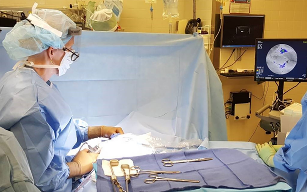 Image: Surgeon using a hand-held probe to scan the lumpectomy cavity looking for additional tumor to remove (Photo courtesy of Mass General Brigham)