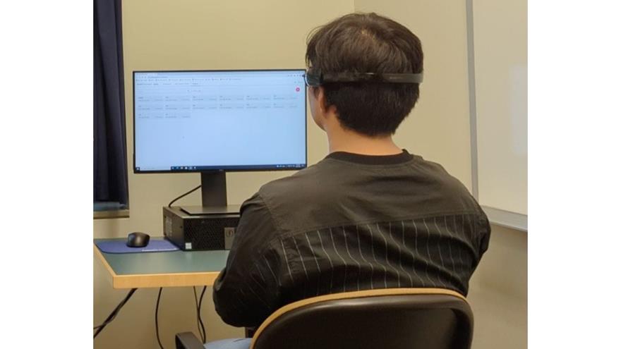 Image: Postdoctoral researcher Yongtaek Oh wearing the EEG device (Photo courtesy of Drexel University)