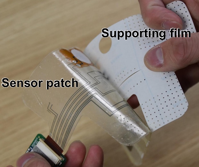 Image: The smart sensor patch is fabricated on a supporting film so that it may be peeled off and stuck onto the skin (Photo courtesy of Guren Matsumura, et al. Device)