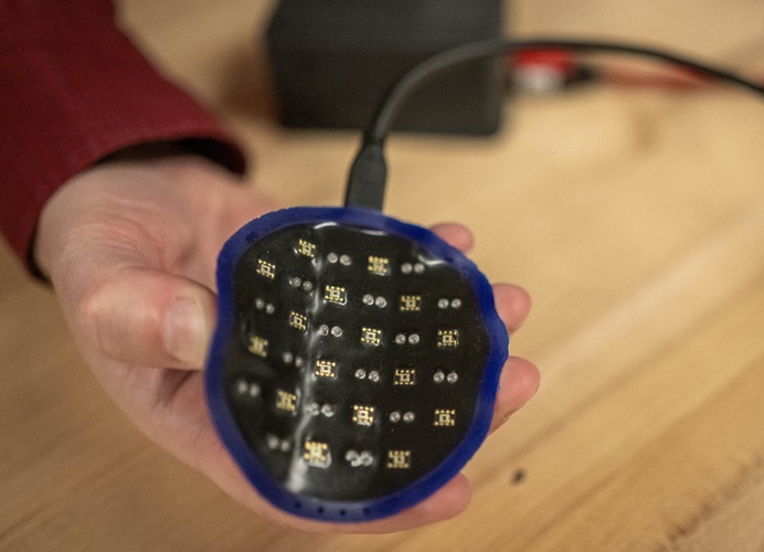 Image: This handheld scanner is moved over breast tissue to monitor how well breast cancer tumors respond to chemotherapy or radiation treatment (Photo courtesy of Boston University)