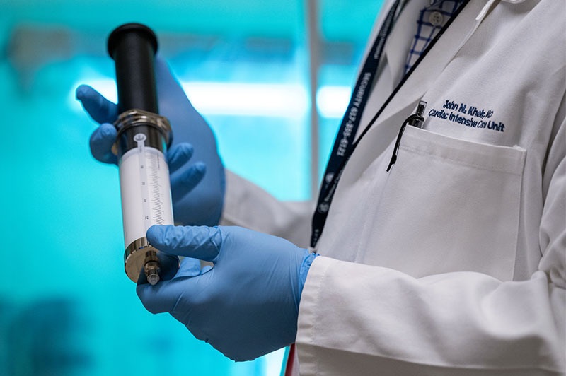 Image: Big syringe, little bubbles: John Kheir, MD, holds the microbubbles that aim to provide emergency oxygen (Photo courtesy of Michael Goderre/Boston Children’s Hospital)