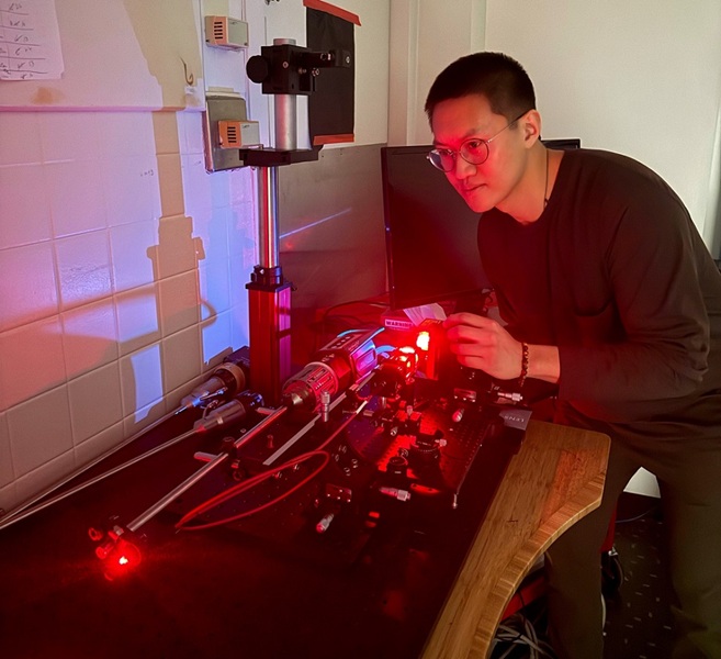 Image: Graduate researcher Anthony Song is shown operating the optical setup (Photo courtesy of Johns Hopkins University)