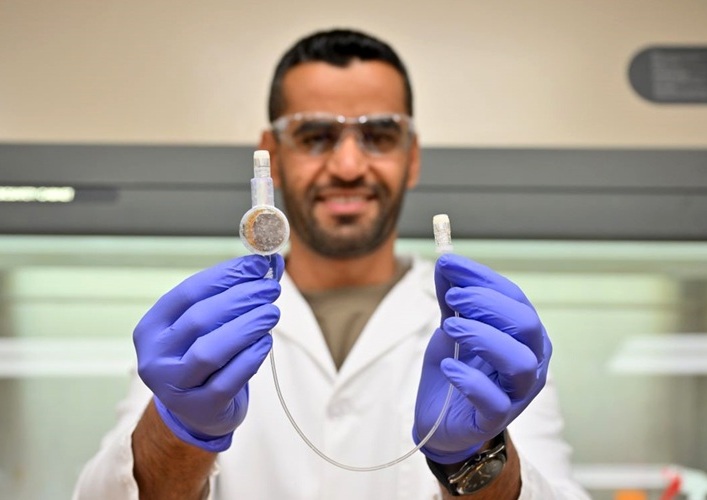 Image: The e-catheter hub, shown here by Majid Al-Qurahi, is designed to kill a common type of bacteria responsible for hospital infections (Photo courtesy of WSU)