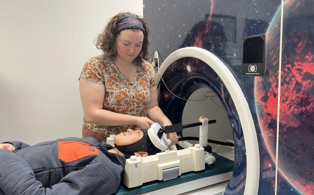 Image: Researchers in Jing Jiang’s lab demonstrate concurrent TMS-fMRI technology (photo courtesy of Jing Jiang Lab, University of Iowa Health Care)