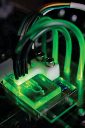 Image: Artificial blood vessels on a microfluidic chip; the researchers used a device that simulated blood flowing through narrowed coronary arteries to assess effects of anticlotting drugs (Photo courtesy of the Georgia Institute of Technology).