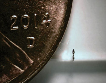 Image: Side view of the microrobot next to a US penny (Photo courtesy of Purdue University).