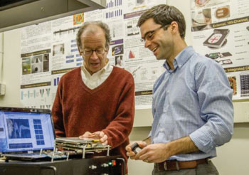 Image: Arto Nurmikko, left, David Borton, and colleagues have developed a neural transmitter that can stream data from the brain to researchers while subjects sleep, wake, move about, and accomplish tasks. The transmitter can send data continuously for more than 48 hours on a single rechargeable AA battery (Photo courtesy of Brown University).