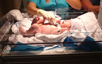 Image: A newborn being evaluated in the NICU (Photo courtesy of Labroots).