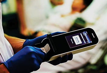 Image: The new Minicare I-20 handheld device detects proteins in the blood stream following a heart attack, providing results in just 10 minutes (Photo courtesy of Philips Healthcare).