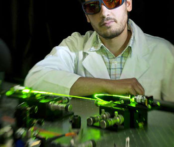 Image: Dr. Georgios Tsiminis in his photonics laboratory (Photo courtesy of the University of Adelaide).