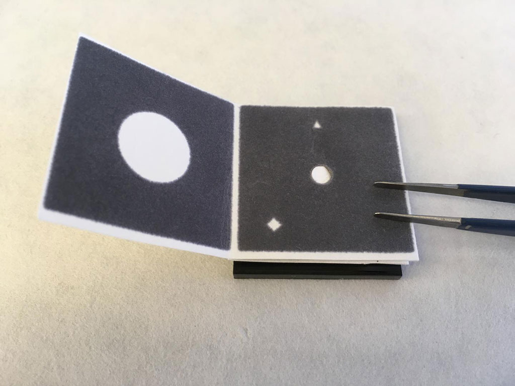 Image: The paper device for COVID-19 detection presents results that are visible to the naked eye: a green circle indicating positive and a blue circle negative (Photo courtesy of Cranfield University)