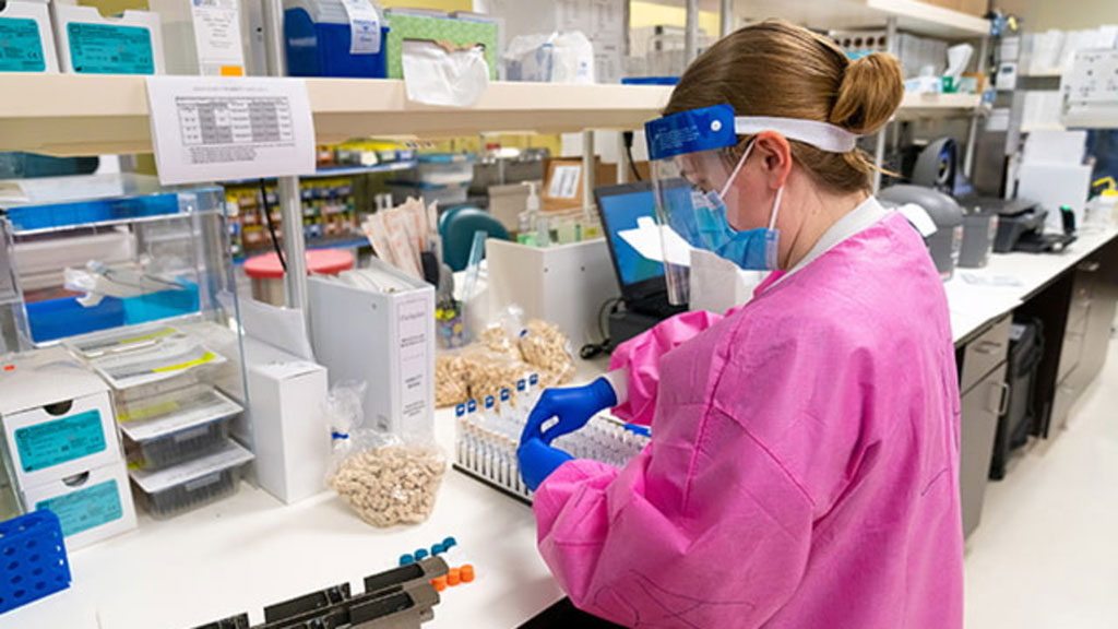 Image: A staff member at the Center for Advanced Laboratory Medicine at UC San Diego Health prepares samples for testing (Photo courtesy of UC San Diego)