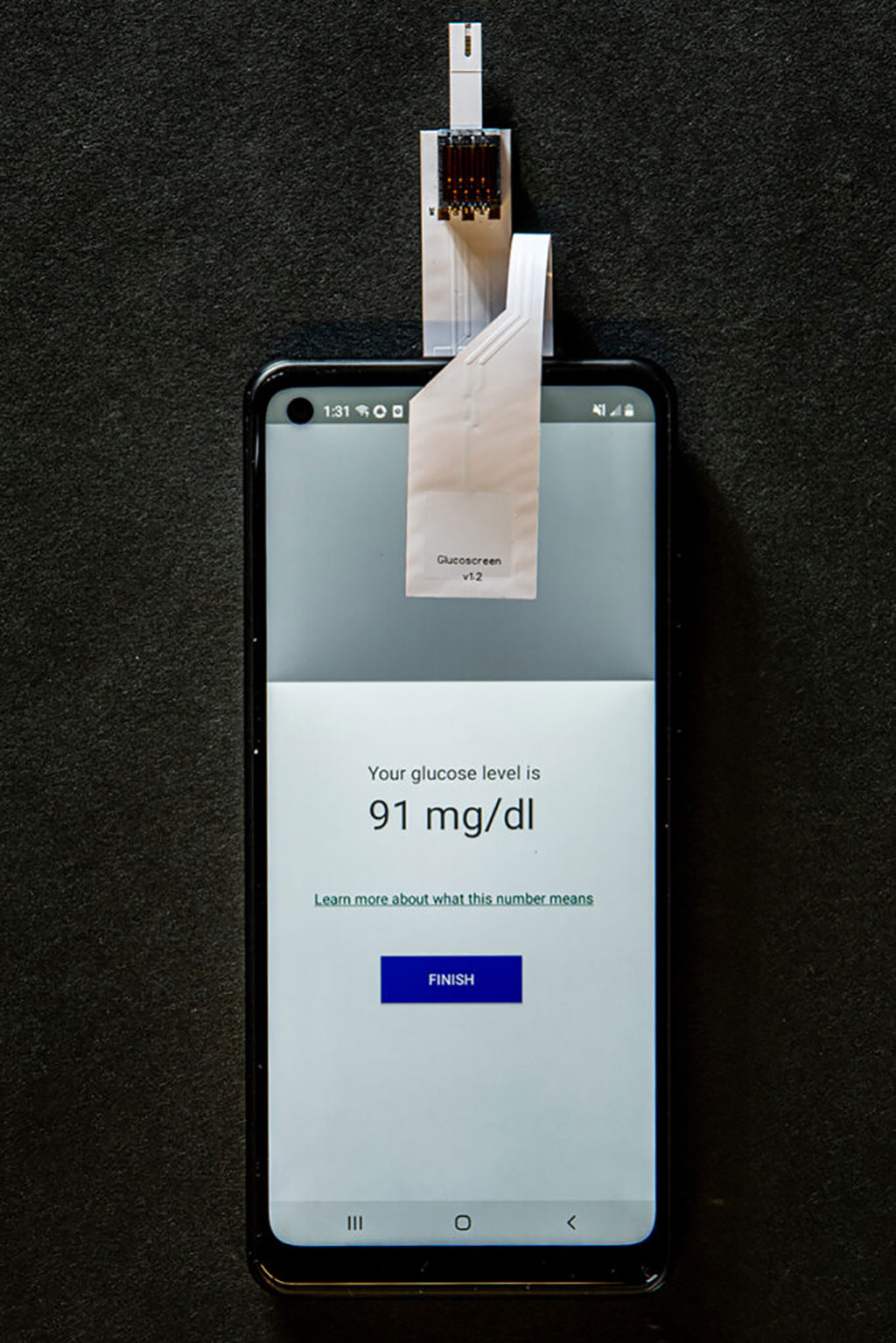 Image: GlucoScreen displays the calculated blood glucose reading on the phone (Photo courtesy of University of Washington)