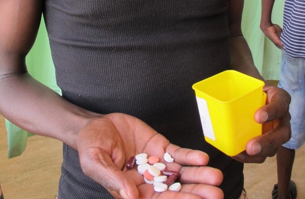 Image: A patient in Namibia receives his daily ration of tuberculosis medication (Photo courtesy of Christoph Lange/DZIF)