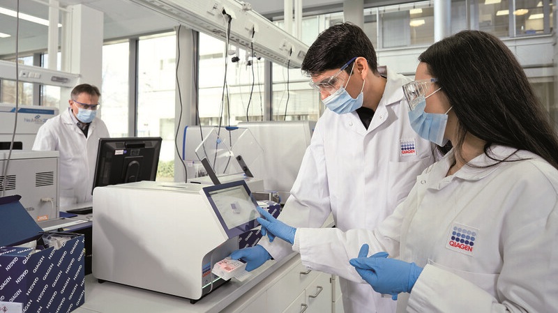 Image: Researchers running syndromic testing on the QIAstat-Dx Analyzer. (Photo courtesy of Qiagen)