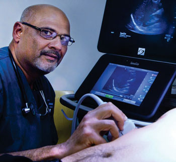 Image: Rip Gangahar alongside the Sonosite X-Porte ultrasound system (Photo courtesy of Fujifilm Sonosite).