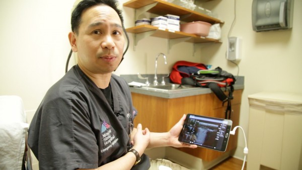 Image: Dr. James Tsung, MD, showcases a lung ultrasound display on a tablet (Photo courtesy of Mount Sinai Hospital).