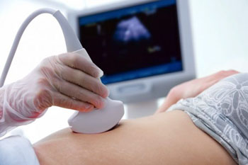 Image: A physician conducts a first-trimester ultrasound exam (Photo courtesy of Science Daily).