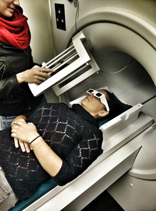Image: A researcher entering the fMRI scanner wearing 3D glasses (Photo courtesy of Ohio State University).