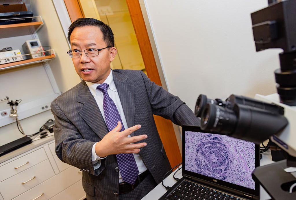 Image: Dr. Baowei Fei demonstrating HSI of tissue (Photo courtesy of UTD).