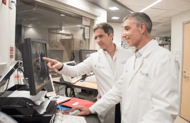 Image: Dr. Luciano Sposato (left) and Dr. Rodrigo Bagur (right) reviewing a patient scan (Photo courtesy of Rena Panchyshyn/LHSC)