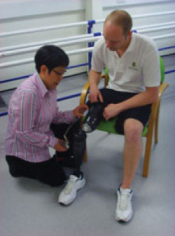 Image: Dr. Liudi Jiang fitting the liner to a prosthetic limb (Photo courtesy of the University of Southampton).