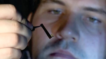 Image: PhD student Christopher Pateman with one of the NGCs (tiny yellow object at center) (Photo courtesy of the University of Sheffield).