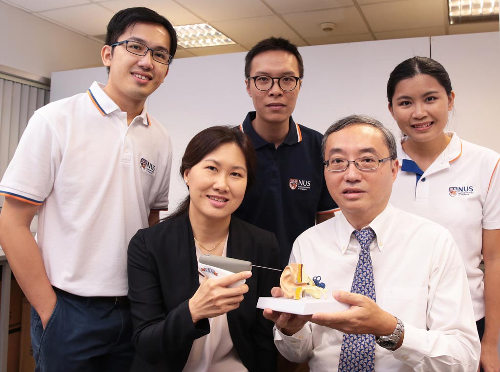Image: NUS researchers with the handheld CLiKX device (Photo courtesy of NUS).