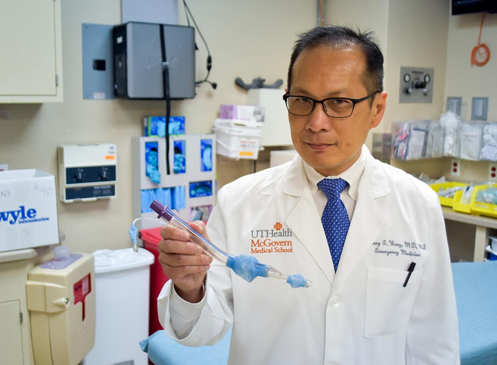 Image: Lead author Dr. Henry Wang holding a laryngeal tube (Photo courtesy of Rob Cahill/ UTHSCSA).