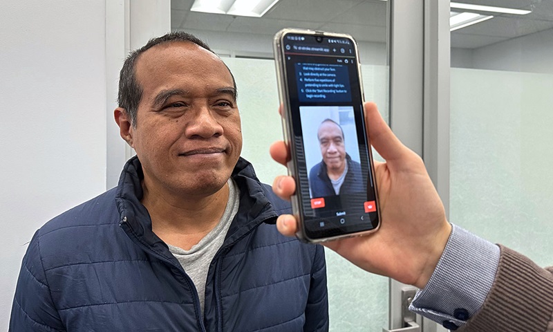 PhD scholar Guilherme Camargo de Oliveira demonstrates the face screening tool with Visiting Associate Professor Nemuel Daniel Pah (left) (Photo courtesy of Seamus Daniel, RMIT University)