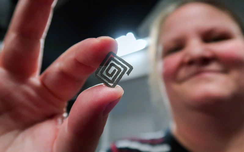 Image: Professor Kate Fox from RMIT’s School of Engineering holds a spiral-shaped prototype of the diamond–titanium implantable device (Photo courtesy of Shu Shu Zheng, RMIT University)