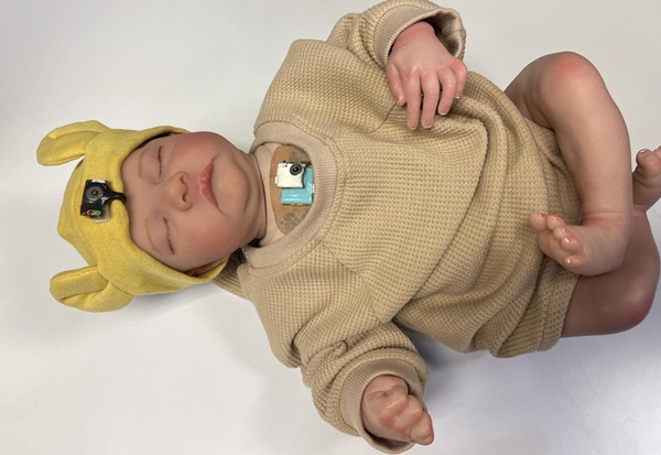 Image: Wearable chest-mounted patch and forehead-mounted pulse oximeter shown on a mannequin baby for illustration (Photo courtesy of Georgia Tech)
