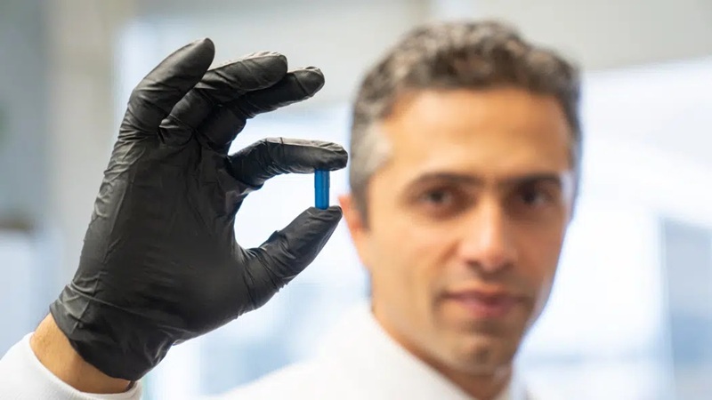 Image: Saman Maleki, PhD, holding a ‘poop pill’ that could help cancer patients respond to immunotherapy (Photo courtesy of LHSCRI)
