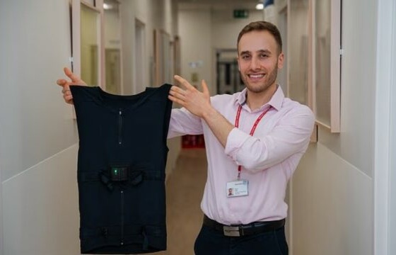 Image: Dr Keenan Saleh, Clinical Research Fellow at Imperial College London, holds up the smart T–shirt (Photo courtesy of British Heart Foundation/Imperial College London)