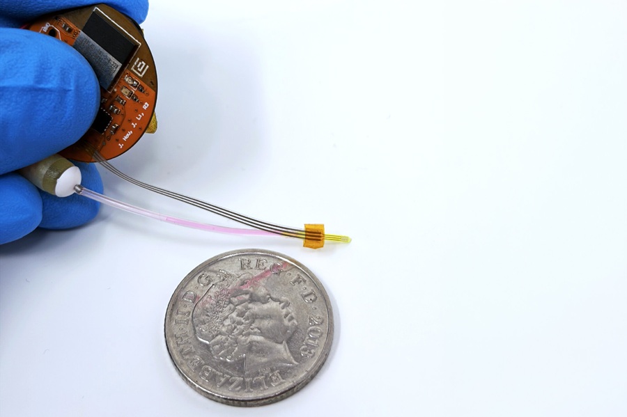 Image: The LUCID prototype, which combines a miniature ultrasound device with a fluid-delivery tube, an osmotic pump and custom electronics. A coin provides a sense of scale. The system is designed to deliver substances directly into brain tissue and uses ultrasound to help them spread. (Photo courtesy of MIT) Image: The LUCID prototype, which combines a miniature ultrasound device with a fluid-delivery tube, an osmotic pump and custom electronics. A coin provides a sense of scale. The system is designed to deliver substances directly into brain tissue and uses ultrasound to help them spread. (Photo courtesy of MIT)