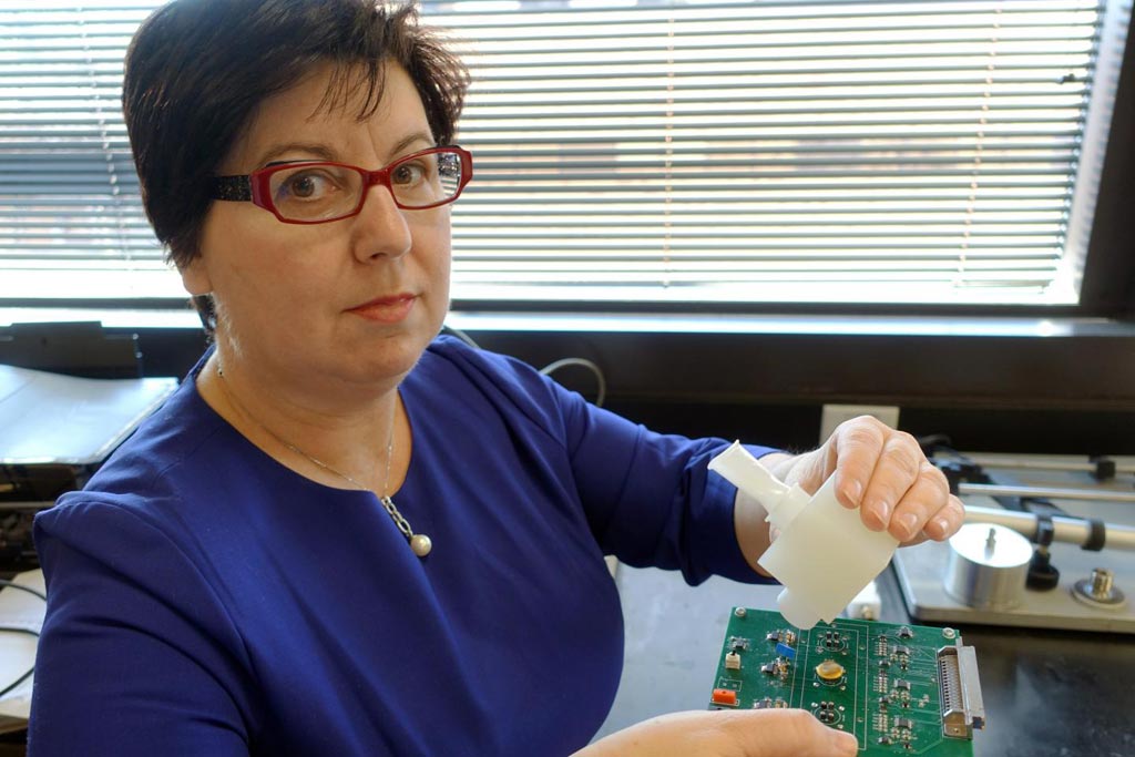 Image: Dr. Perena Gouma displays a hand-held breath monitor that can detect the flu virus (Photo courtesy of the University of Texas, Arlington).