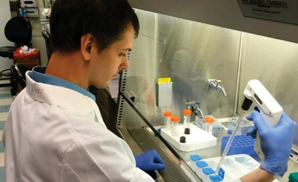 Image: A scientist assembling the cartridge assay that distinguishes cancer from benign aspirates from mammographically suspicious breast lesions (Photo courtesy of Wanjun Ding).