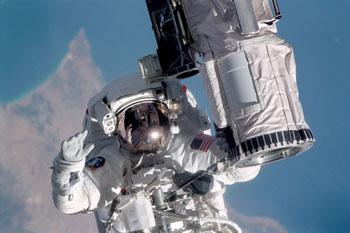 Image: Mission specialist Michael Gernhardt performing a spacewalk (Photo courtesy of NASA).