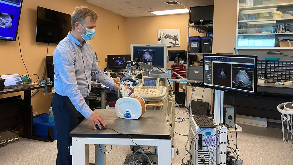 Image: Dr. Derek Cool demonstrating the new robotic 3D ultrasound system (Photo courtesy of Lawson Health)